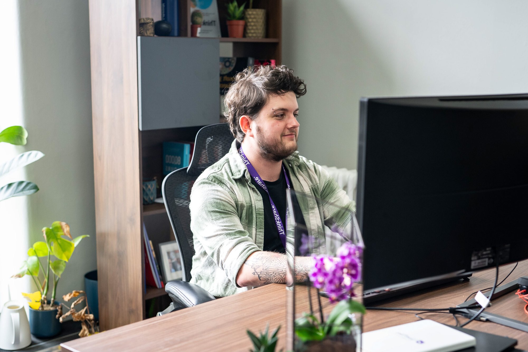 Man sitting at a desk working on a computer.